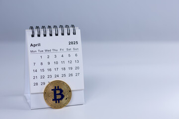  April 2025 calendar and bitcoin coin on white bacground