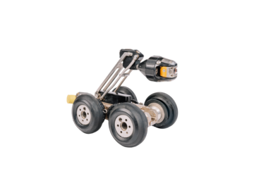 A robotic inspection device with four wheels and a mounted camera, designed for industrial or pipeline inspections. Isolated on white background.