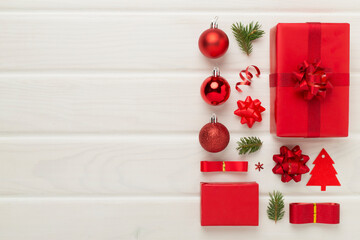 Handmade wrapped christmas gift boxes with stuff on wooden background, top view