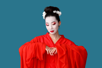 Obraz premium Beautiful young geisha on blue background
