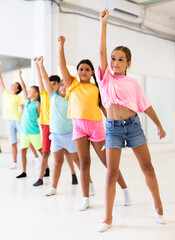 Fototapeta premium Boys and girls standing in row on their group dance classes.