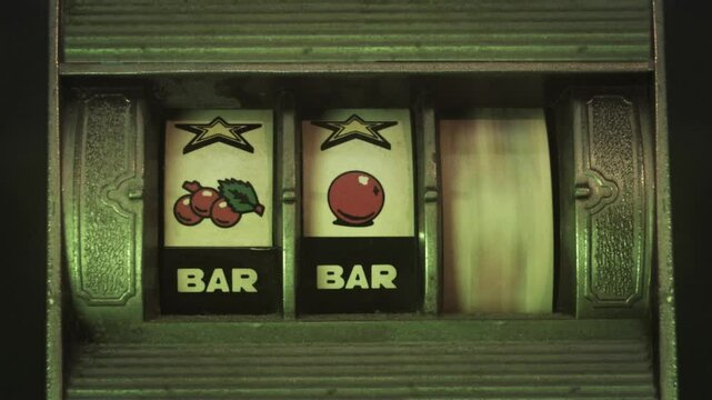 A Casino Fruit Slot Machine while Rolling And Giving Results. Close Up video shot with flashing lights