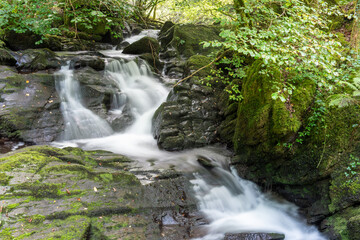 Fototapeta premium Long exposure of a waterfall at Watersmeet in Exmoor National Park