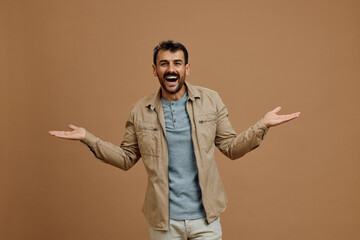 Studio shot of cheerful man gesturing while looking at camera.