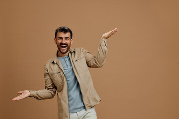 Studio shot of cheerful man balancing with his hands on neutral background. Copy space.