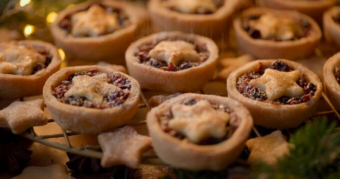Christmas mince pies sprinkled with icing sugar, close-up view. Traditional british Christmas dessert