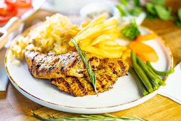 Tender grilled porterhouse or t-bone steak served with crisp golden French fries and fresh green herb salad accompanied by a BBQ or tomato ketchup sauce