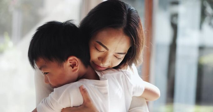 Happy, hug and Asian mom with child in home for bonding, love and healthy relationship by window. Family, childhood and Japanese mother with boy embrace for affection, care and support in house