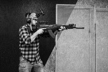 A private military in civilian clothes practices tactical shooting with night vision and a ak rifle...