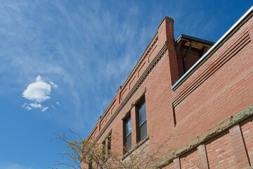 Brick parapet wall  beneath solitary cloud