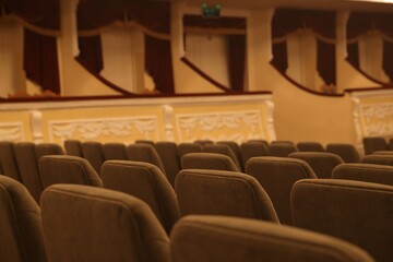 Rows of gray comfortable seats in theatre, closeup