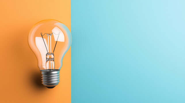 single lightbulb on vibrant orange and blue background, symbolizing creativity and innovation. contrasting colors highlight bulb simplicity and elegance, evoking sense of inspiration
