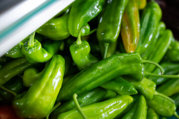 Green ripe bell peppers on supermarket shelves