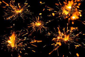 Christmas sparkle background. Light fire sparkle. Abstract golden fire sparkle isolated on a black background. New year sparkle on black background.