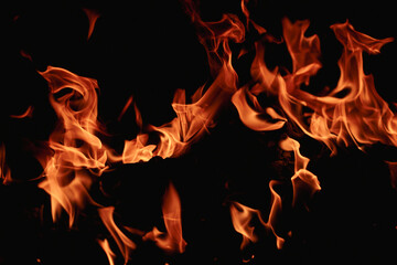 Fire over black background. Fire sparks background. Abstract blaze flames background. Burning fire....