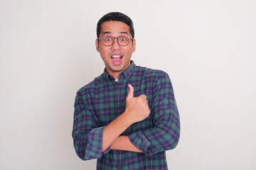 A man give thumbs up with amazed expression