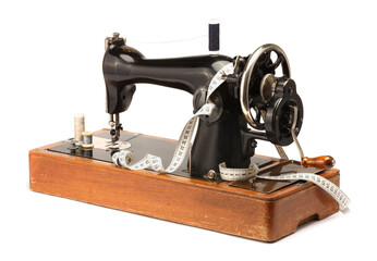 Sewing machine, measuring tape and spools of threads isolated on white