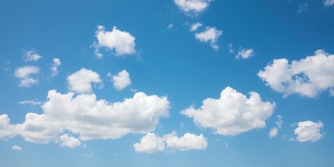 Obraz premium Fluffy white clouds scattered across a bright blue sky, atmosphere, pattern