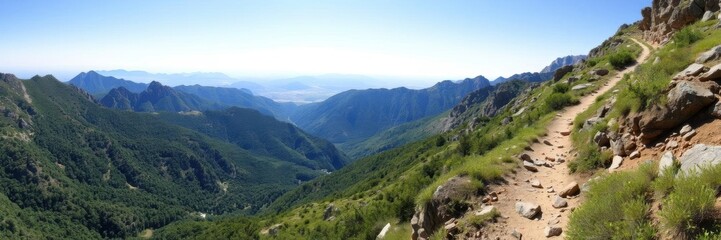 A panoramic view of a rugged mountain trail with lush greenery and clear blue skies, exploration, tranquil