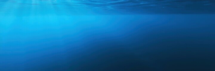 Dark blue ocean surface seen from underwater with sunlight streaming through the water, peaceful, blue