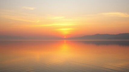 Fototapeta premium A serene image of a lake reflecting the warm hues of the setting sun, creating a tranquil atmosphere, clouds, sunset