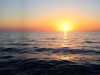 Fototapeta premium Vibrant sunrise over a calm ocean, casting a golden glow on the water and creating a peaceful atmosphere, morning, colorful