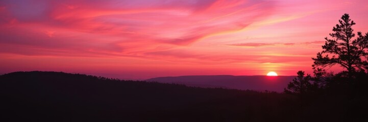 Obraz premium Vibrant gradient of orange, pink, and purple hues in a dramatic, beautiful sunset over a silhouette of a forest, beautiful, serene