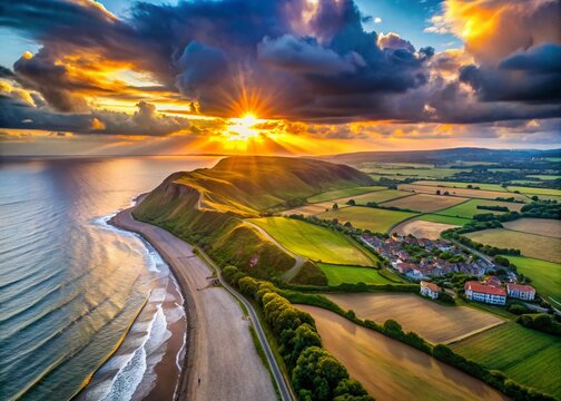 Panoramic Aerial View of Muckleburgh Hill and Weybourne at Sunrise, Capturing Dramatic Grey Clouds Over the Sea and Sheringham in the Distance, Norfolk, England