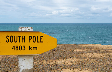 Southernmost point new zealand directions sign with ocean background