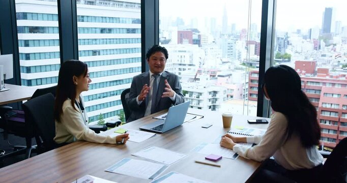 Group, business people and collaboration with documents, pitch and discussion for meeting in office. Teamwork, paperwork and communication for brainstorming, project and company as proposal in Japan