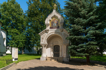 View of the monument-chapel of D.M. Pozharsky with a memorial cross in the architectural and museum complex of the Spaso-Evfimiev Monastery on a sunny summer day, Suzdal, Vladimir region, Russia
