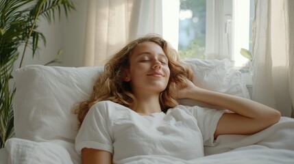 Young woman relaxing in bed, eyes closed, peaceful morning.