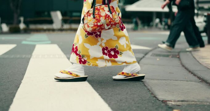 Walking, person and shoes with kimono for Japanese fashion, culture clothes and heritage style. Woman, slippers or zori with floral dress for pedestrian crossing, travel and journey in city of Tokyo
