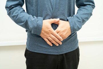 Hernia, Asian man stomach ache, abdominal pain and urology problem health.