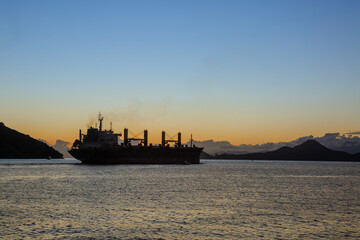 Silhouette of a cargo ship leaving the port of Santos