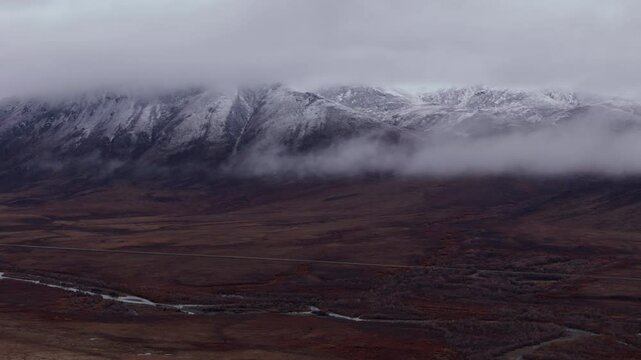 Clouds Over Snowy Ogilvie Mountains In Yukon, Canada - Drone Shot