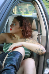 beautiful woman in a car wearing big leather boots