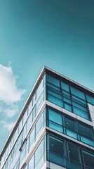 Fototapeta premium Modern Architecture: A sleek, modern office building reaches towards a vibrant blue sky, showcasing its contemporary design and glass facade. The image evokes a sense of ambition, progress.
