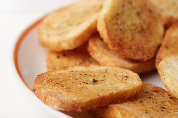 Close-up view of crispy bread crackers on white background