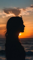 Silhouette of a Woman at Sunset: A solitary figure stands against the fiery backdrop of a sunset, her silhouette casting a poetic mystery against the vast expanse of the ocean.