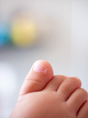 Newborn baby foot close-up family home personal photography warm environment intimate perspective cherishing moments together