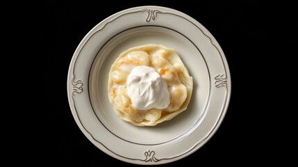 Deliciously Steamed Dumplings with Creamy Topping Served on an Elegant Plate Against a Black Background