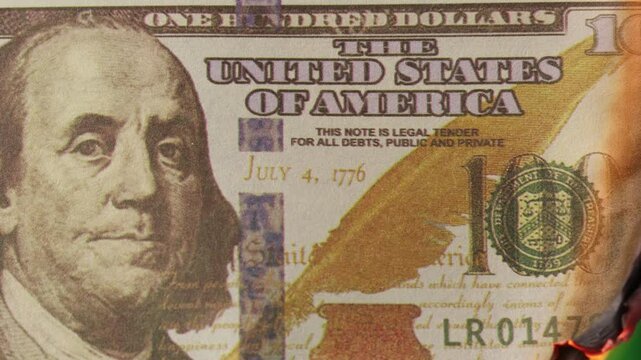 close up on100 dollar banknote burned with green screen.
