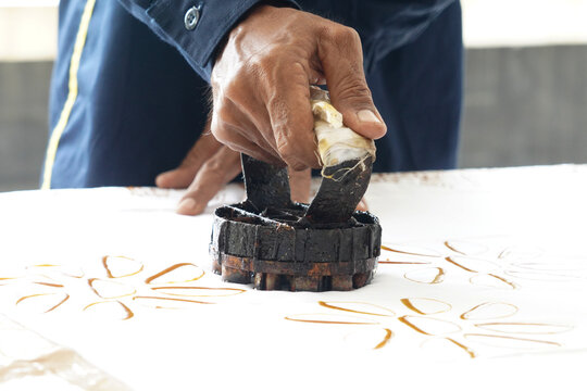 Close-up view of the batik stamping process. Making batik cloth by stamping.
