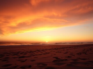 Obraz premium A picturesque beach scene at sunset with a warm orange sky, calm sea, seashore, white sand