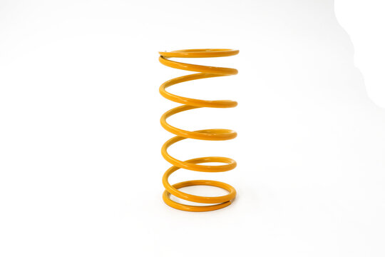 long spiral springs on car suspension system parts, replacement parts for iron objects, motorbike parts, isolated on a white background