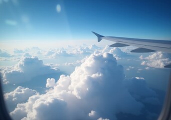 Obraz premium View of clouds from an airplane wing during a daytime flight over the sky