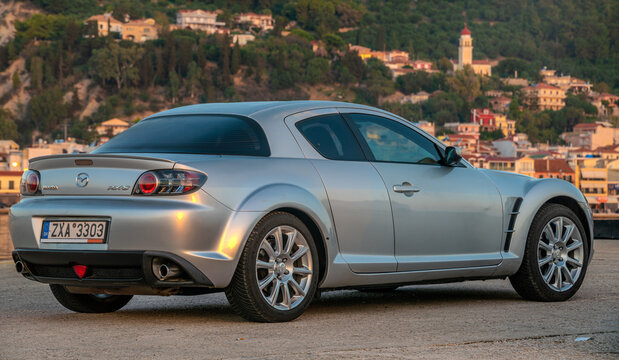 Legendary Mazda RX-8 with wankel engine against the backdrop of a port city