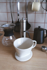 Ingredients and equipment for making coffee. Different ways to make alternative coffee - ceramic V60, glass Chemex, small teapot for brewing coffee, manual coffee grinder. Kitchen at home. 