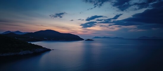 Fototapeta premium Serene twilight over a tranquil sea with dark blue waters and a captivating sky during evening hours